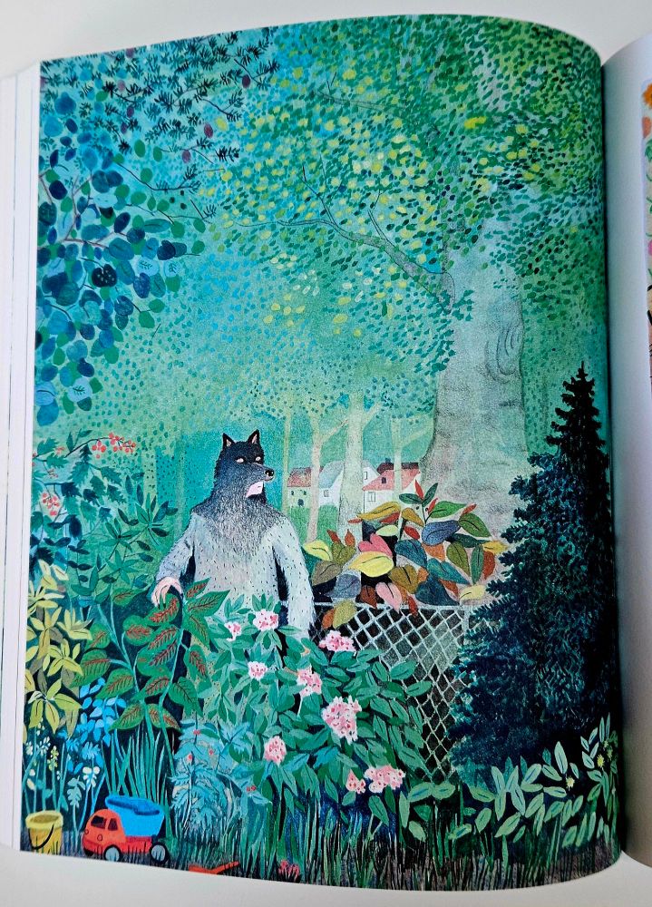 Inner pages of Juliette. A man dressed as a wolf in a beautiful garden with kids' toys in the foreground. 