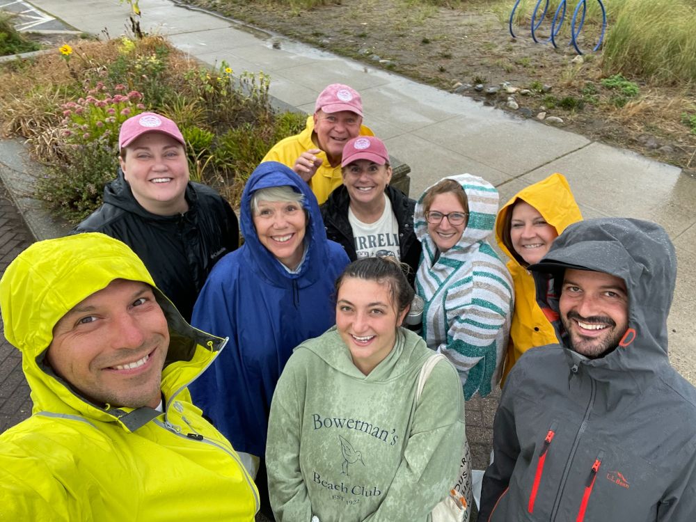 A small group of volunteers gathered after a Yirrell Beach cleanup, smiling up at the camera.
