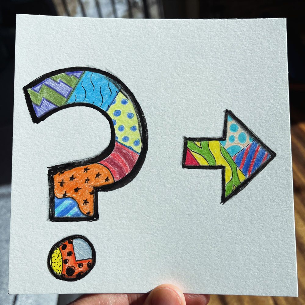 a handmade drawing of a question mark and an arrow pointing to the right, both filled with a patchwork of colorful patterns