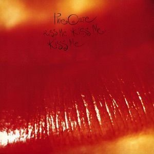 The cover for The Cure’s album “Kiss Me Kiss Me Kiss Me.” It features a blurry close-up of lips coated in shiny red lipstick.