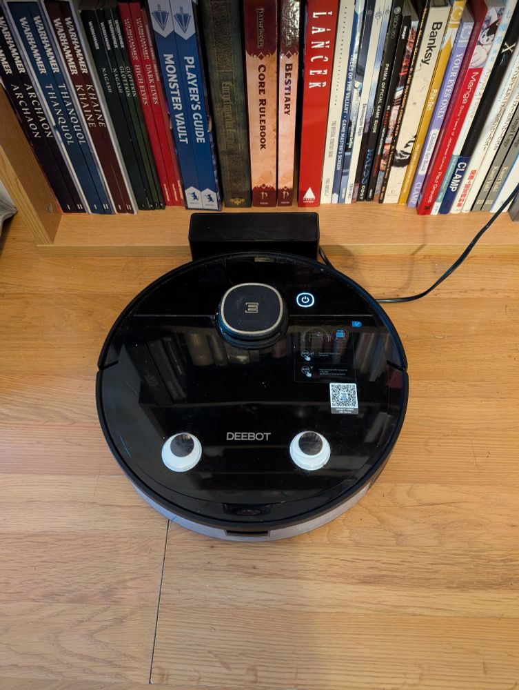 Photo showing roomba with googly eyes stuck to it