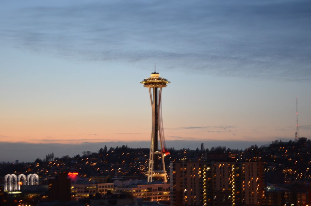 Photo taken near dusk of Seattle's landmark Space Needle and surrounding cityscape