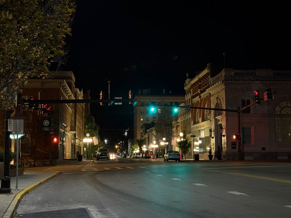 Small town Main Street at night. Brick buildings, traffic lights and lamp posts make a charming picture.