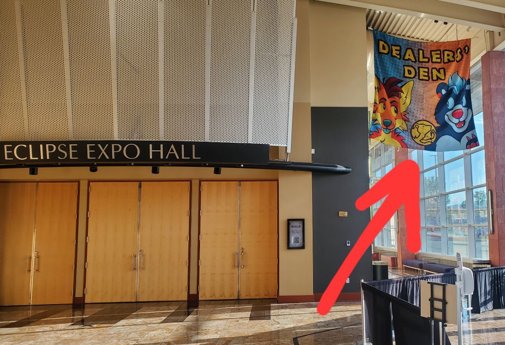 Photo of a large empty foyer

A large 'Dealers' Den' 6 x 6 foot banner hangs from the rafters featuring the mascots of AWU, Arc and Carver

