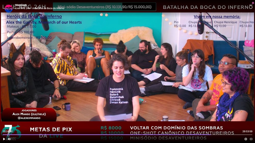 Um screenshot da live na manhã de domingo: a roda continua ali, agora com Fai sentado no centro, lendo um papel.