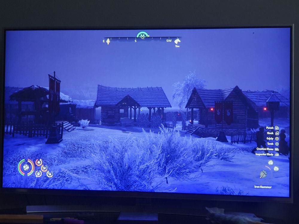 The market square. A well and a clothing stall is on the left, a kitchen on the right, and a tavern in the middle.