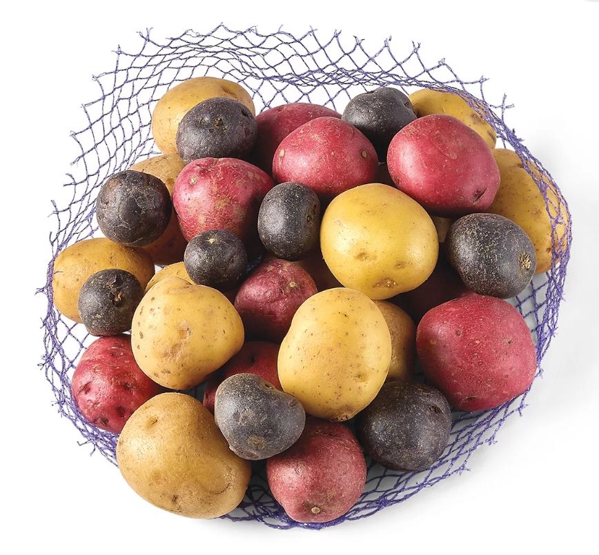 The grocery store’s product image for “Fresh Baby Potato Medley.” It is a pile of baby red, yellow, and blue potatoes sitting on the mesh bag that they come in. 🥔