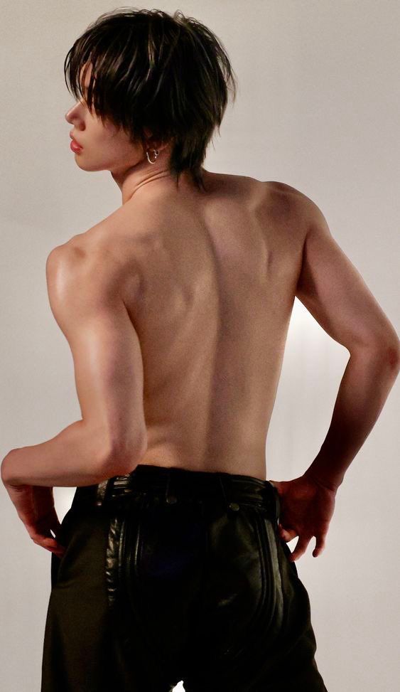 yeonjun for his no labels album…. it’s a picture from behind showcasing his bare back. he’s wearing a pair of black pants that are both cotton and leather. YJ is looking barely to the side over his shoulder, but not at the camera 