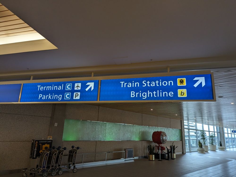 Sign with arrow for Train Station / Brightline.