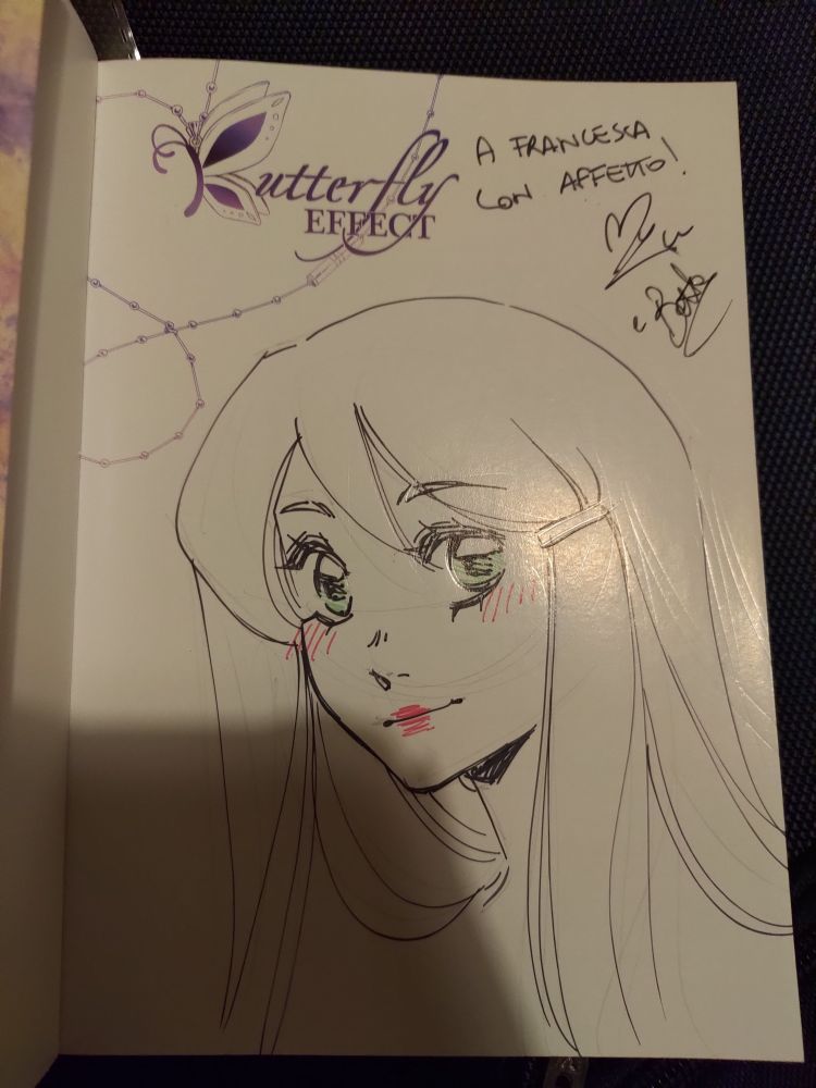 The author of Butterfly effect signed my copy of the first volume. There's also the signing of the comic artist who did the variant cover. The drawing is the protagonist of Butterfly effect.