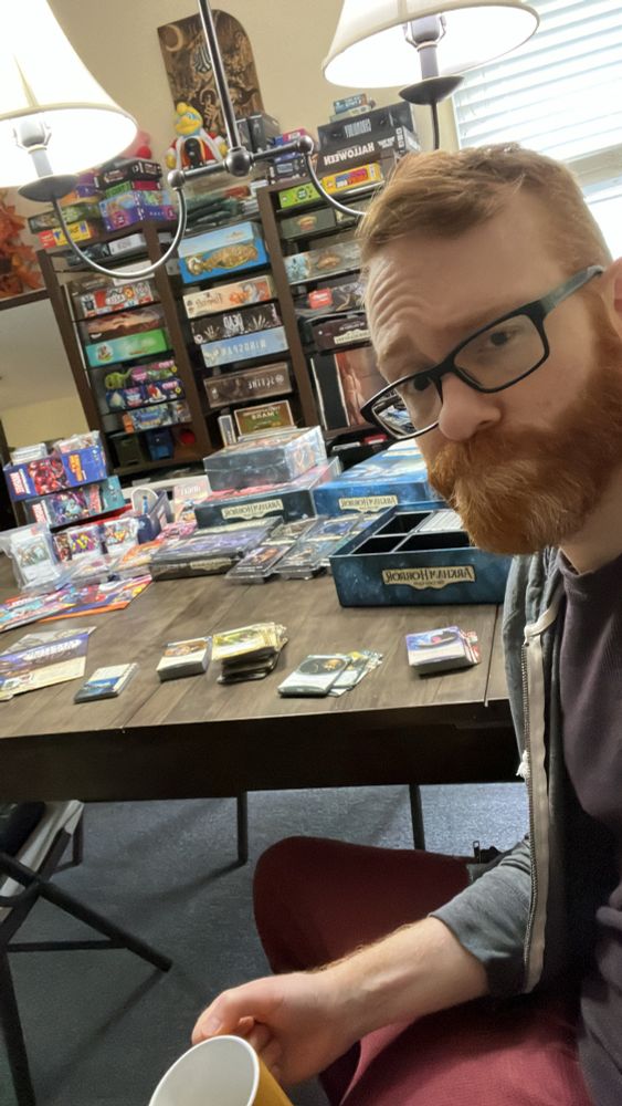 Sitting at the aforementioned gaming table, making sure I have all the copies of the cards I was shipped so I can leave positive feedback. 