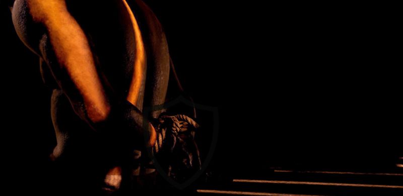 A shadowy figure in a rope bind is illuminated by strips of light in the dark