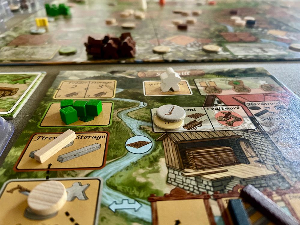 The player board for Lignum mid-game, showing the saw mill with green food cubes, a light brown lumber marker, and light brown  wood marker.
