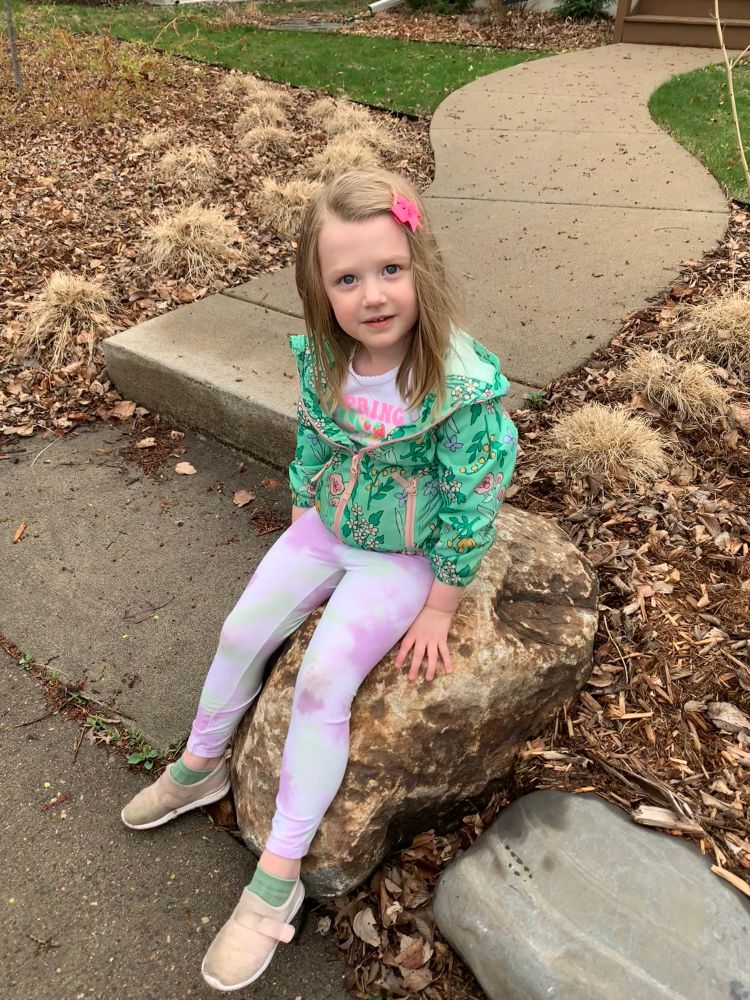Ivy (soon to be 4yrs old) sitting on a walk on our walk home from preschool.