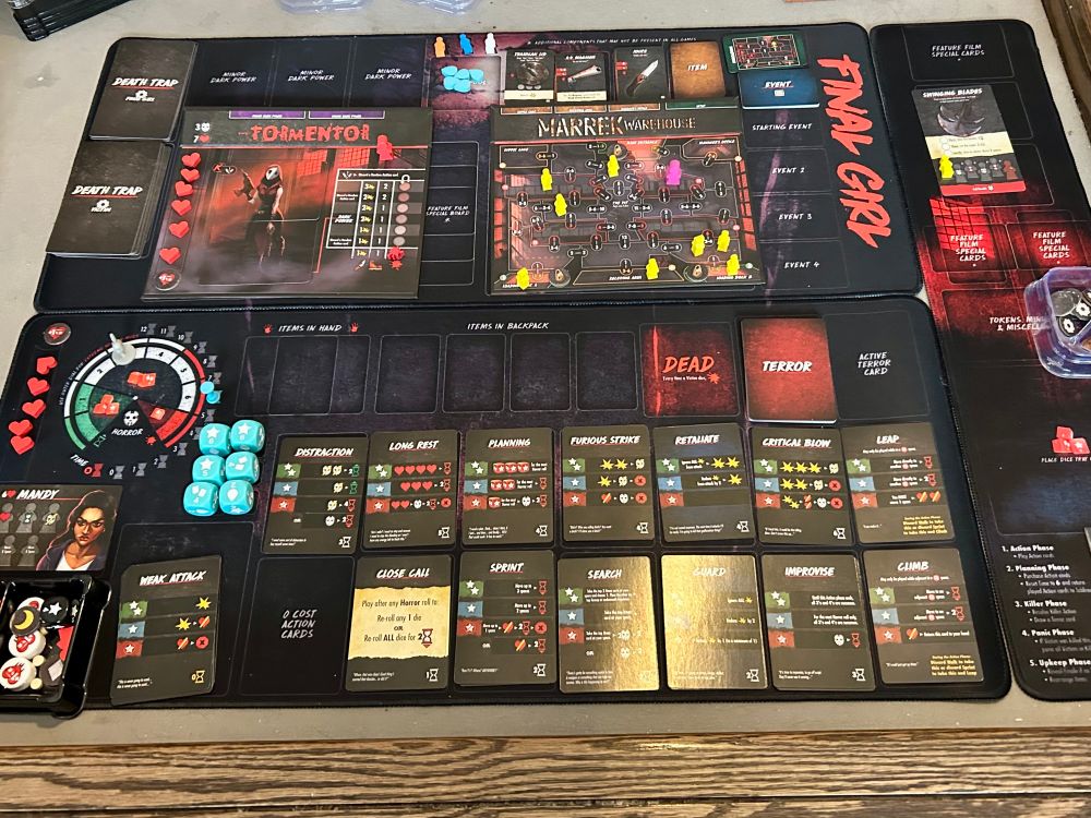 Full board layout of Final Girl with the season 2 mats and tear dice. 