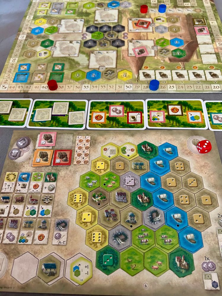Castles of Burgundy player board midway through a game, including the Trade Routes expansion.
