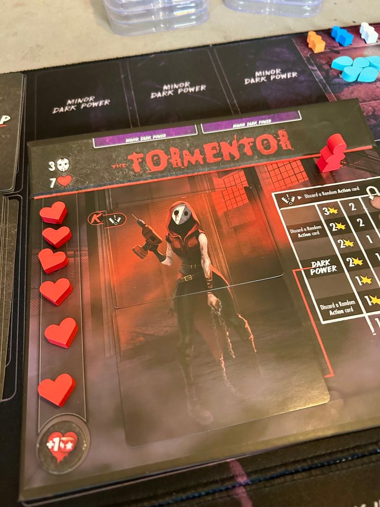 Close up of the Tormentor killer board with a full set of heart tokens.