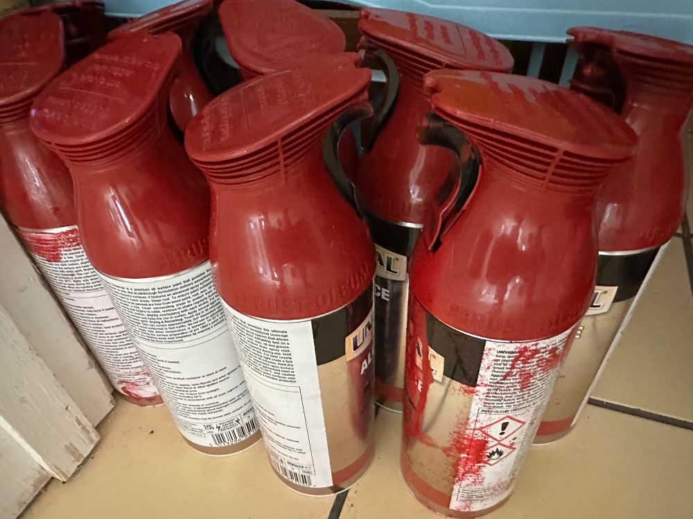 Red spray paint cans.