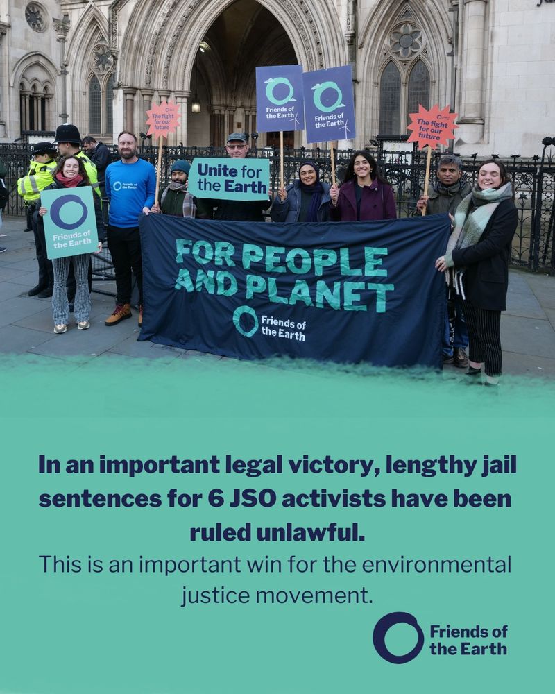 Friends of the Earth campaigners stand outside the Royal Courts of Justice in London. They hold placards saying 'Unite for the earth.', 'The fight for our future', 'For people and planet' and 'Friends of the Earth.