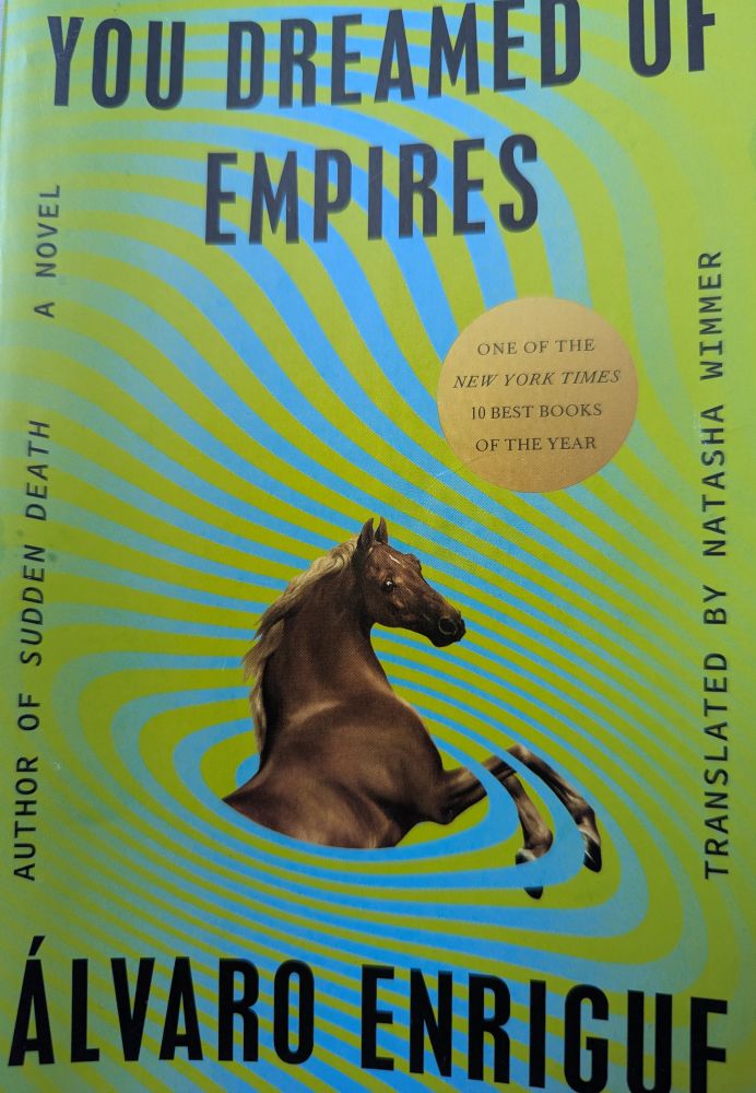 Book cover for "You dreamed of Empires" by Álvaro Enrique, it's hallucinogenic green with a whirling blue strip, out of which a horse emerges