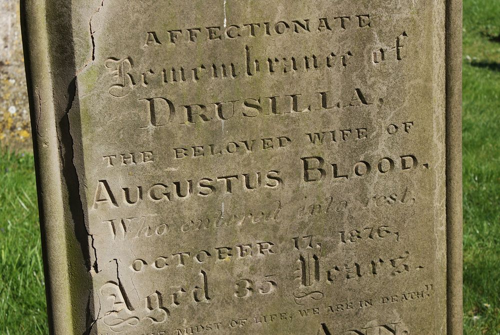 A sandstone headstone which, in gothic lettering reads: "Affectionate remembrance of DRUSILLA, the beloved wife of AUGUSTUS BLOOD. (Illegible line) October 17, 1876, aged 35 years."