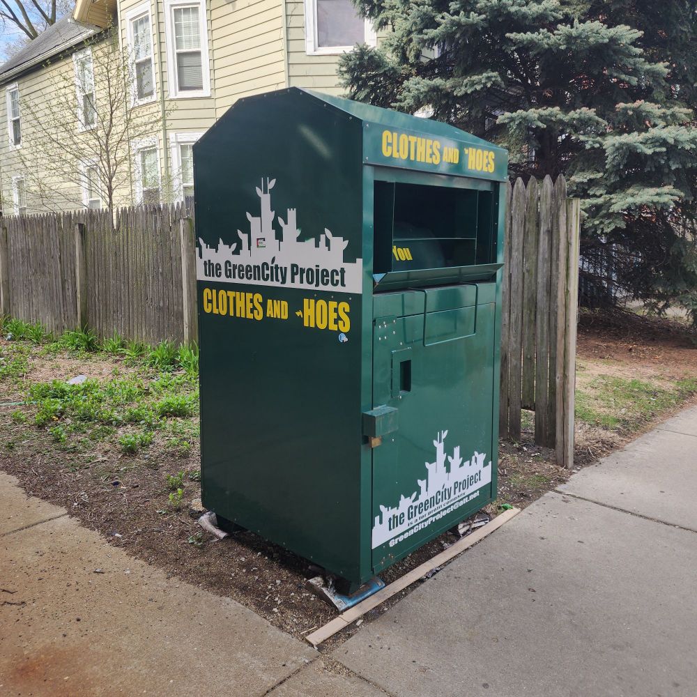 A donation box that originally read, "clothes and shoes" and was defaced to read, "clothes and Hoes"