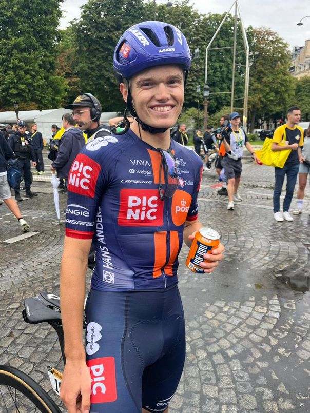 The Scottish  cyclist Oscar Onley at the end of the Tour de France. Holding a tin of Irn Bru.