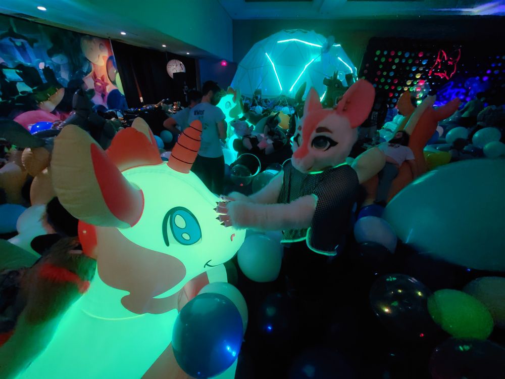 Rat fursuiter Cassie at FWA 2025 AD inflatible room