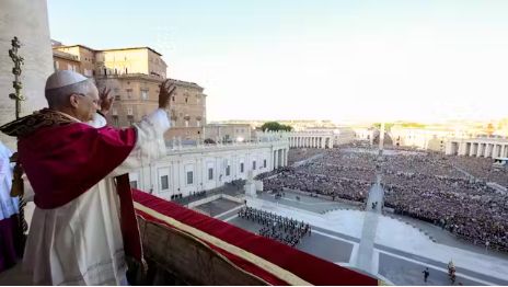 Pope Leo XIV waves to the crowd from the balcony.