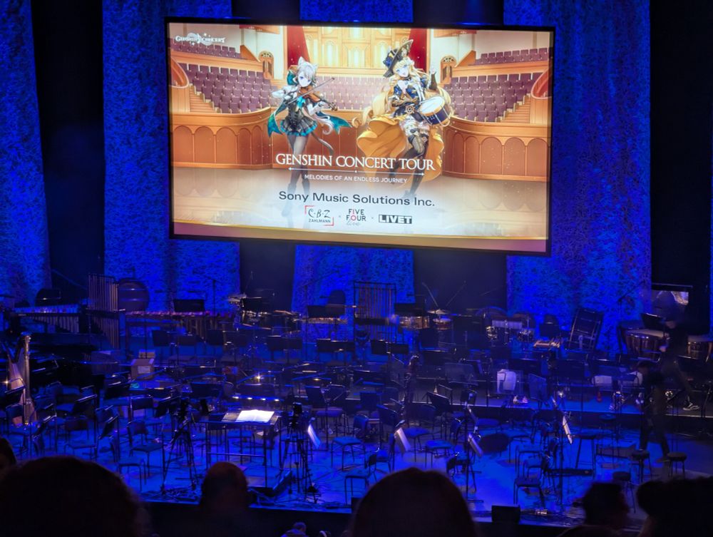 A photo of the stage before a Genshin Impact concert. Lynette and Navia are on a backdrop screen.