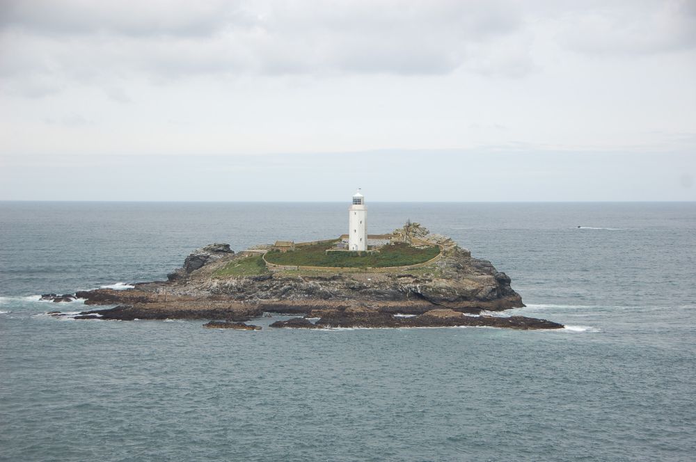 a white lighthouse on a small island