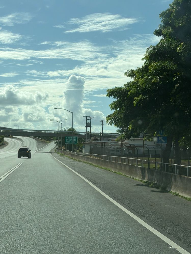 A mostly cloudy morning on Oahu, with a cloud that’s oddly shaped like a wiener and a set of balls in the distance towards Honolulu.  Underneath the clouds are the soon to be opened portion of the Honolulu Rail heading towards the Daniel K Inouye International Airport, followed by three on and off ramps, with the on the left going towards Kamehameha Highway westbound, the middle going towards the H1 freeway heading east, and the right going towards Nimitz Highway eastbound.  Picture taken by me, MrGrimmace, outside of Nimitz Gate at Pearl Harbor.