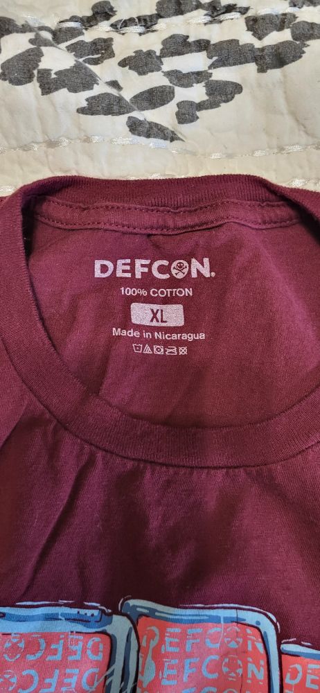Label on a def con shirt that says 
