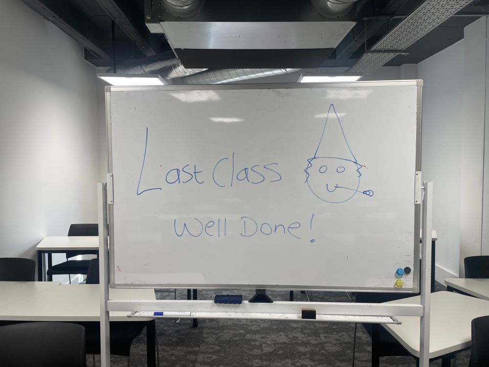 I wrote on a white board last class well done and attempted to draw a party emoji! 