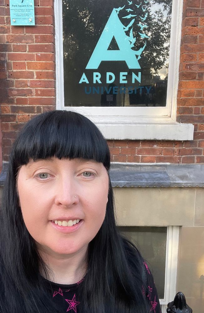 Me outside the uni smiling 