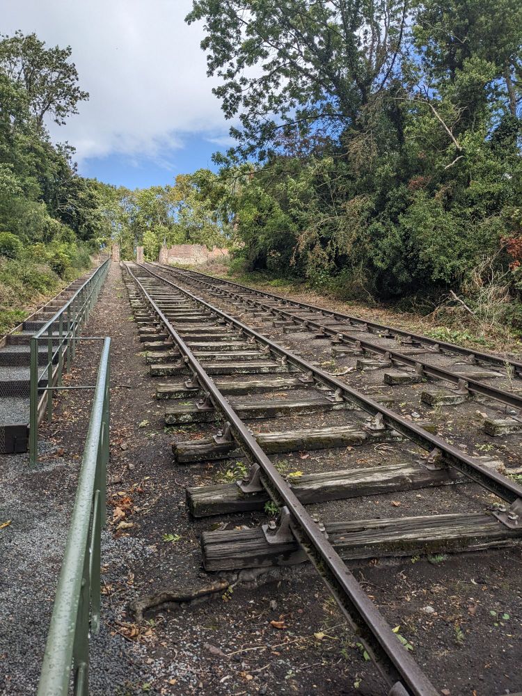 Hay Inclined Plane at Blists Hill museum, Salop, OK. Two parallel sets of rails run up a hill to a derelict winding house.