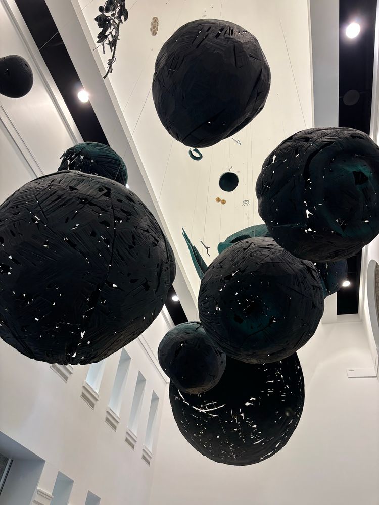 black orbs of unknown material hangong from the ceiling of the lobby at the Columbus Metropolitan Library