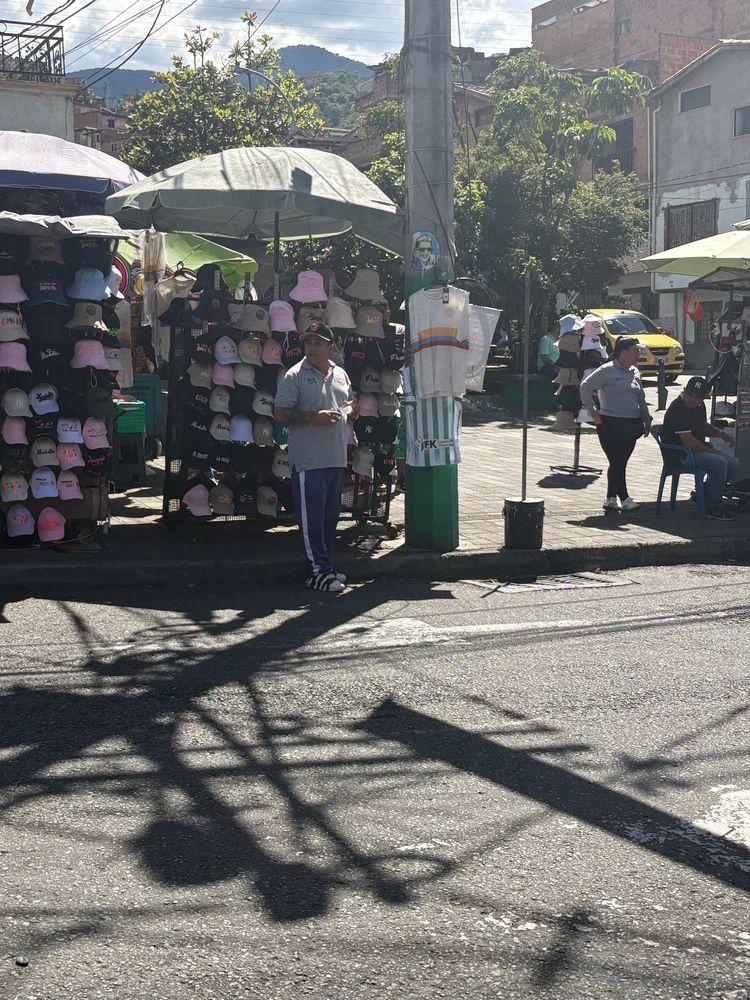 Vendor in communa 13, Medellin, Colombia. 🇨🇴 selling hats. 