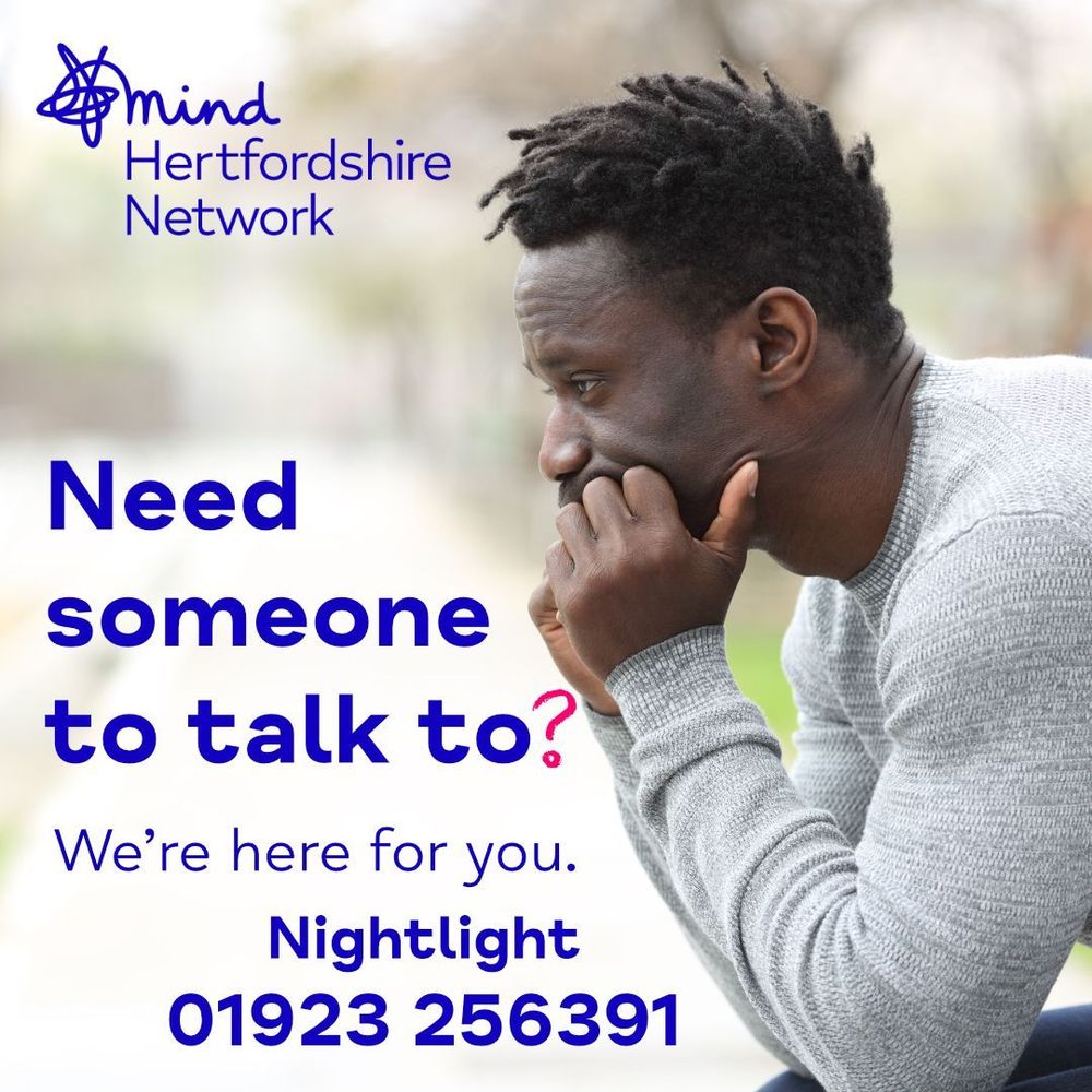 A man sits outdoors, looking thoughtful and resting his chin in his hands. The text reads, “Need someone to talk to? We’re here for you.” Below, it says, Nightlight 01923 256391