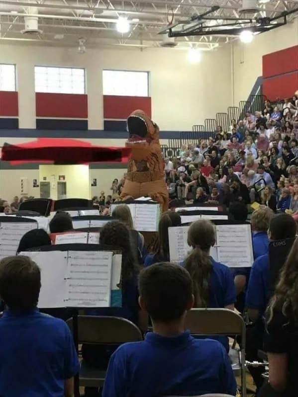 Dinosaur directing a school band