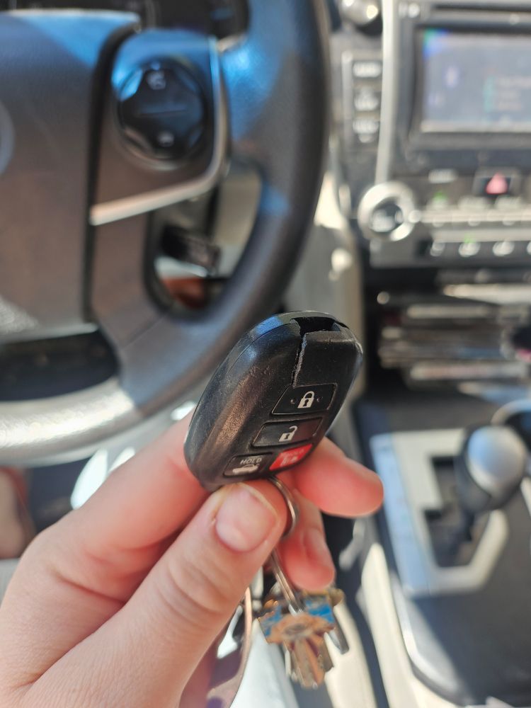 A car key fob with broken plastic 