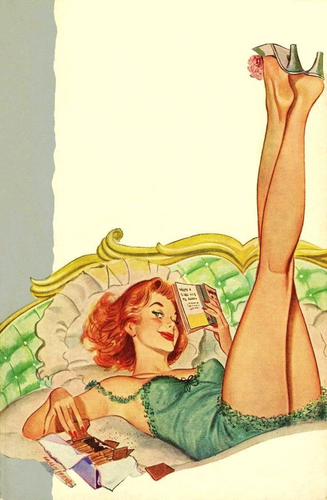 A white red headed woman eating chocolate on her bed with her legs up