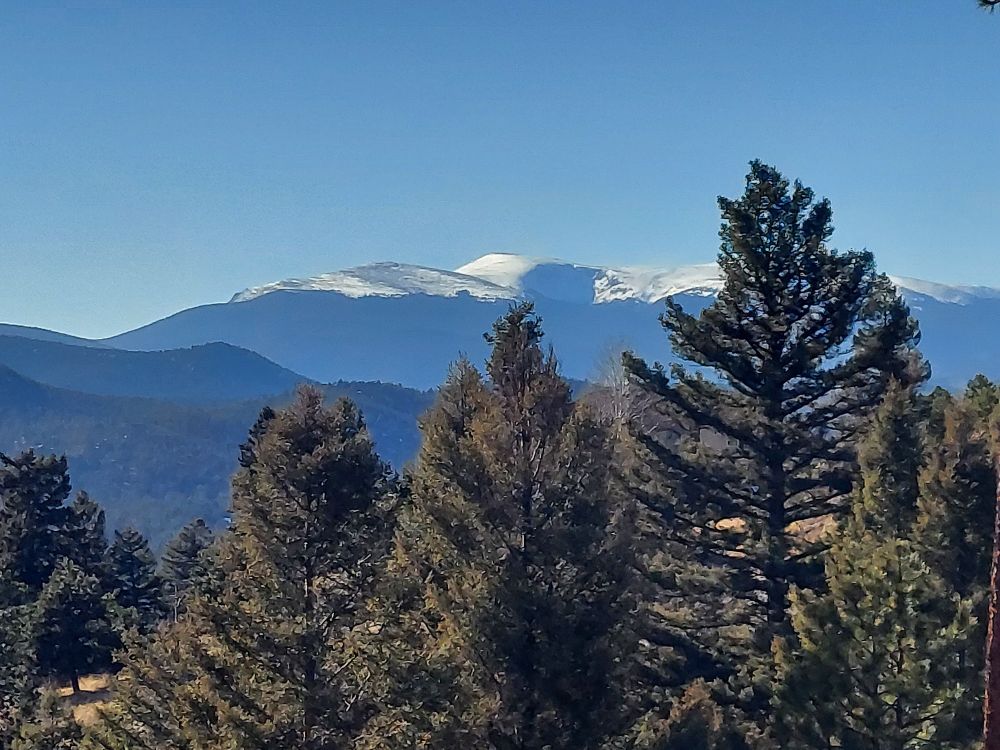 Mountain landscape featuring a snowcapped Mt Logan which has a large cirque in it.