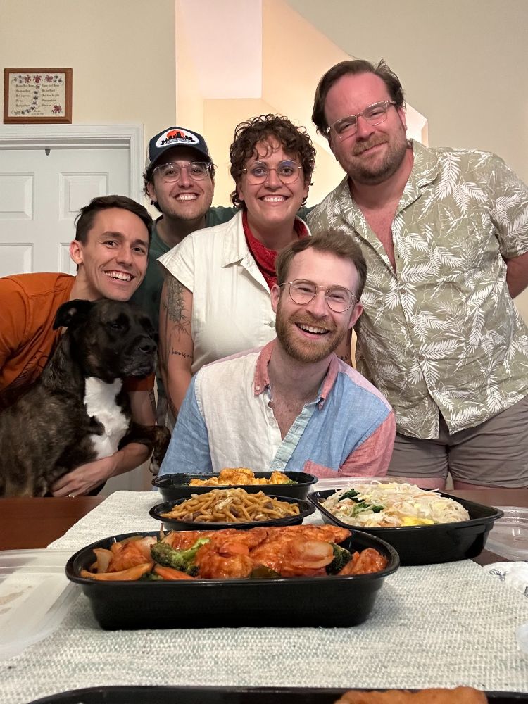 Will, Mike, thier dog Jo, and 3 friends around the dinner table