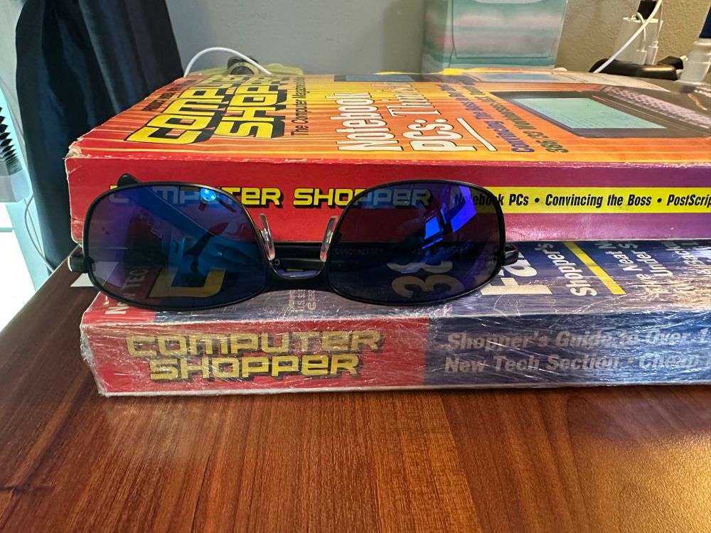 The spine of 2 computer shopper magazines from 1991. Also a pair of sunglasses for reference since the are taller than the sunglasses 