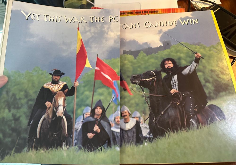 Ad showing men dressed in medieval attire, 2 riding horses and the ad says “yet this war the pc titans cannot win”