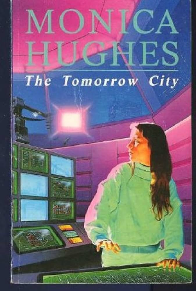 The book cover for The Tomorrow City by Monica Hughs.  The author's name is listed at the top and the title is underneath.  A girl in a white sweater and pants with long brown hair is looking over her shoulder at several computer screens and what seems to be a light giving off a pink-white light.  The background looks to be a domed roof with windows and metal walls.