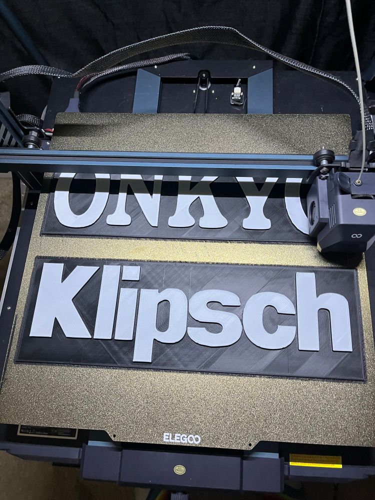 3D printed wall signs that say Onkyo and Klipsch