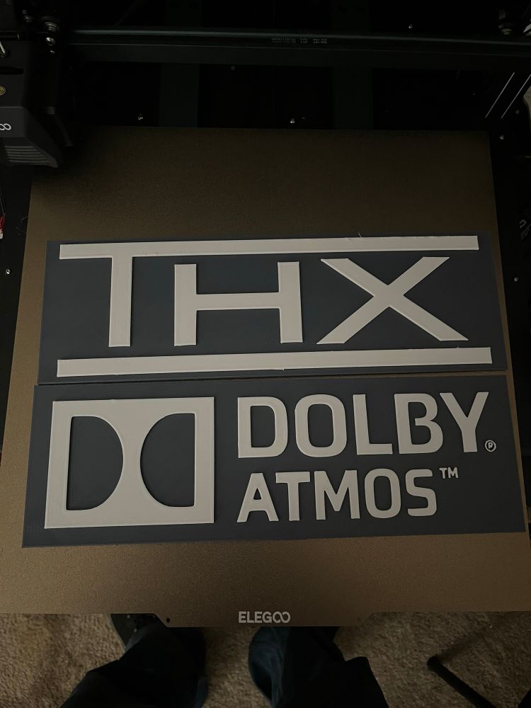 3D printed wall signs that say THX and Dolby ATMOS
