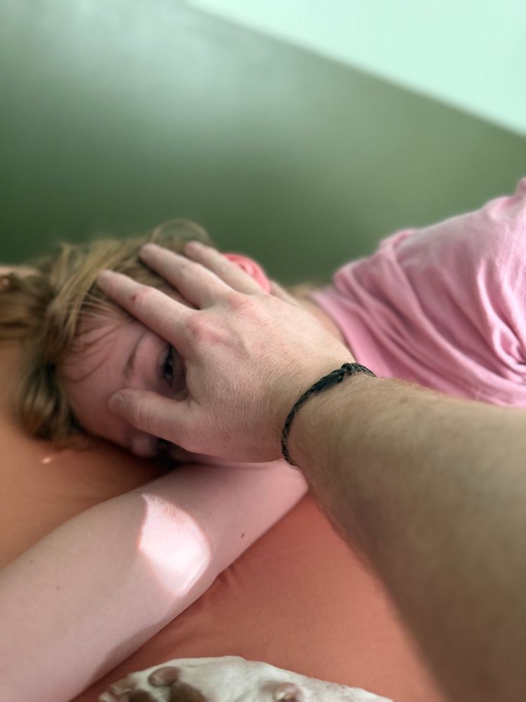 holding my daughters face while she’s laying in bed